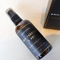Bottle of petrichor dry tobacco & hay room spray on a light surface