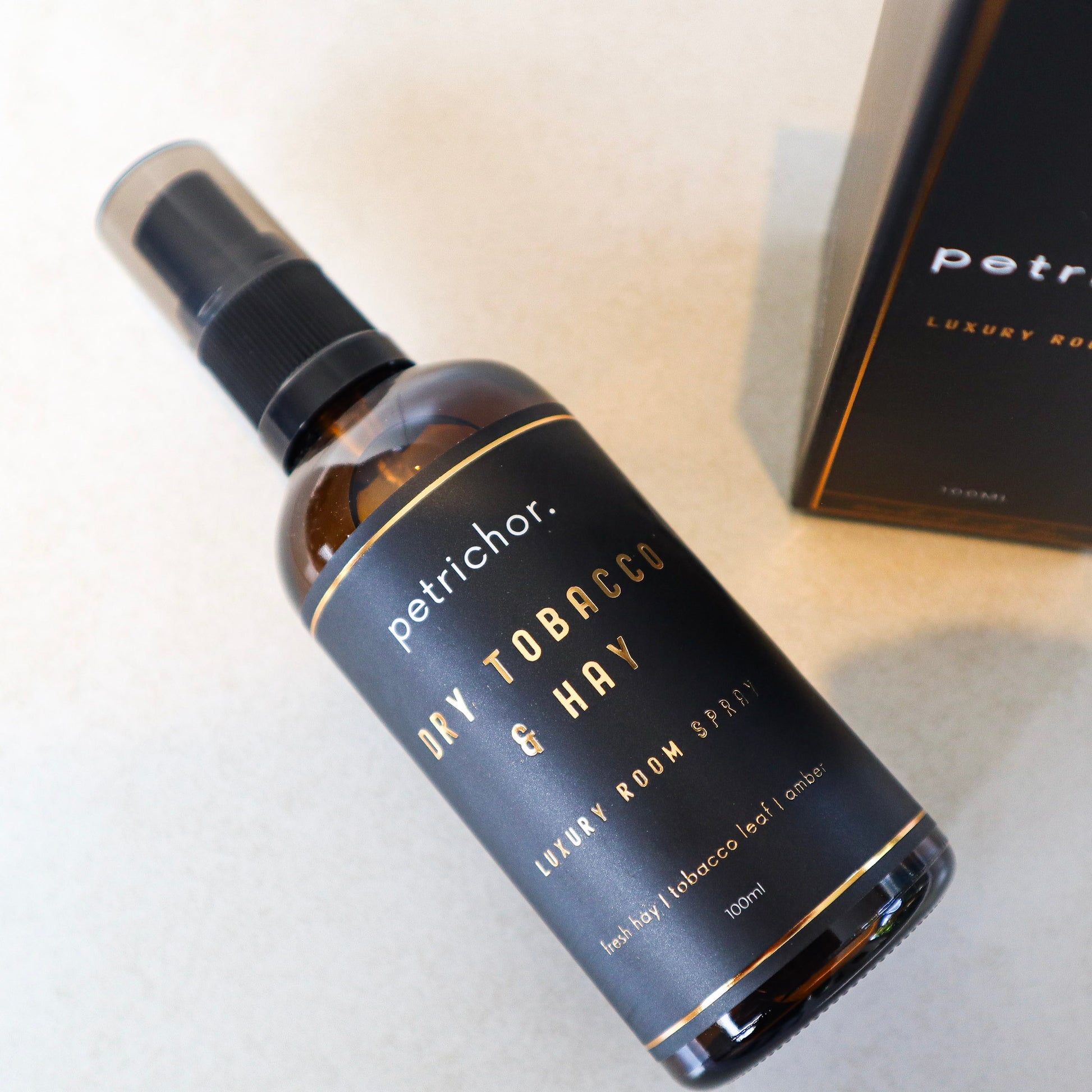 Bottle of petrichor dry tobacco & hay room spray on a light surface