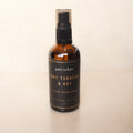 Bottle of petrichor Dry Tobacco & Hay room spray on a beige background
