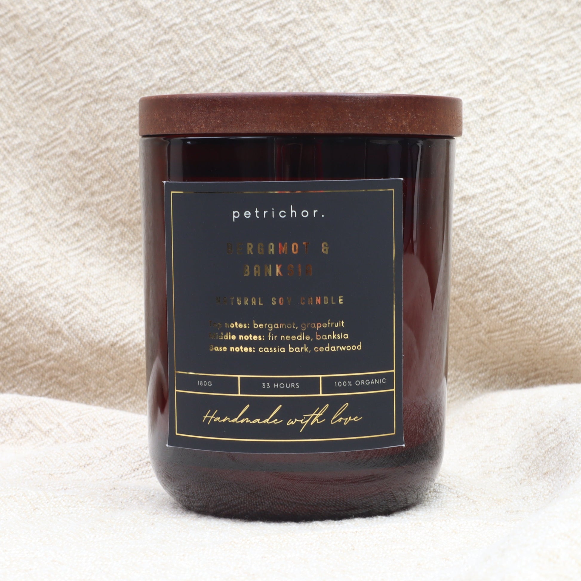 Candle with a label on a textured white background