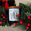 Nutcracker's Waltz Christmas soy candle on a pine wreath with red berries