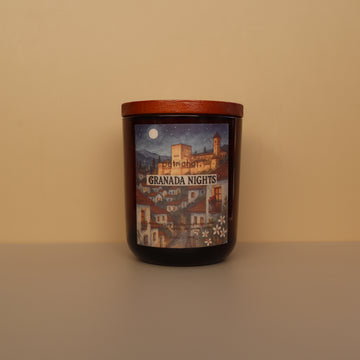Candle with a decorative label featuring a castle and 'Granada Nights' text on a beige background.