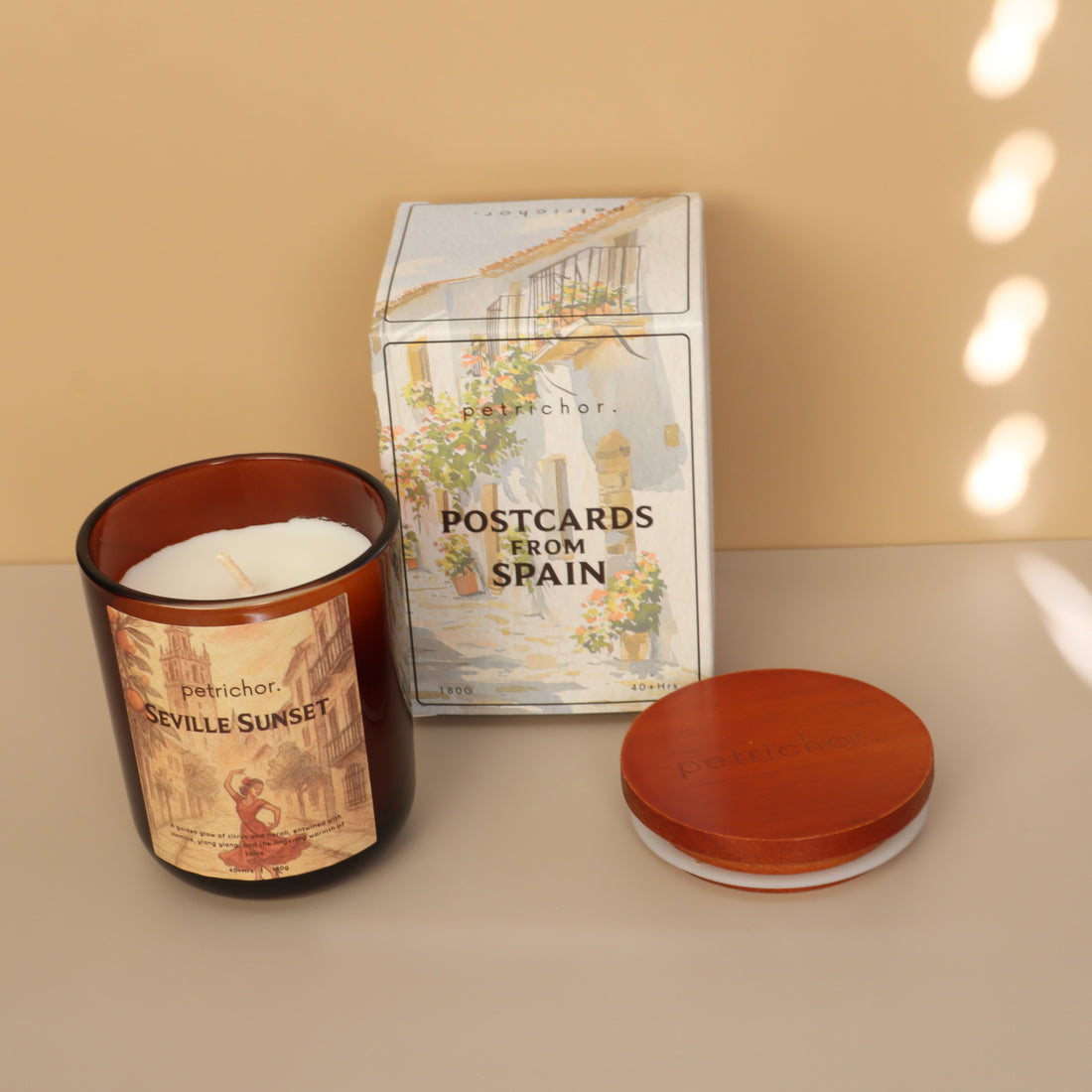 Candle with 'Seville Sunset' label on a beige background