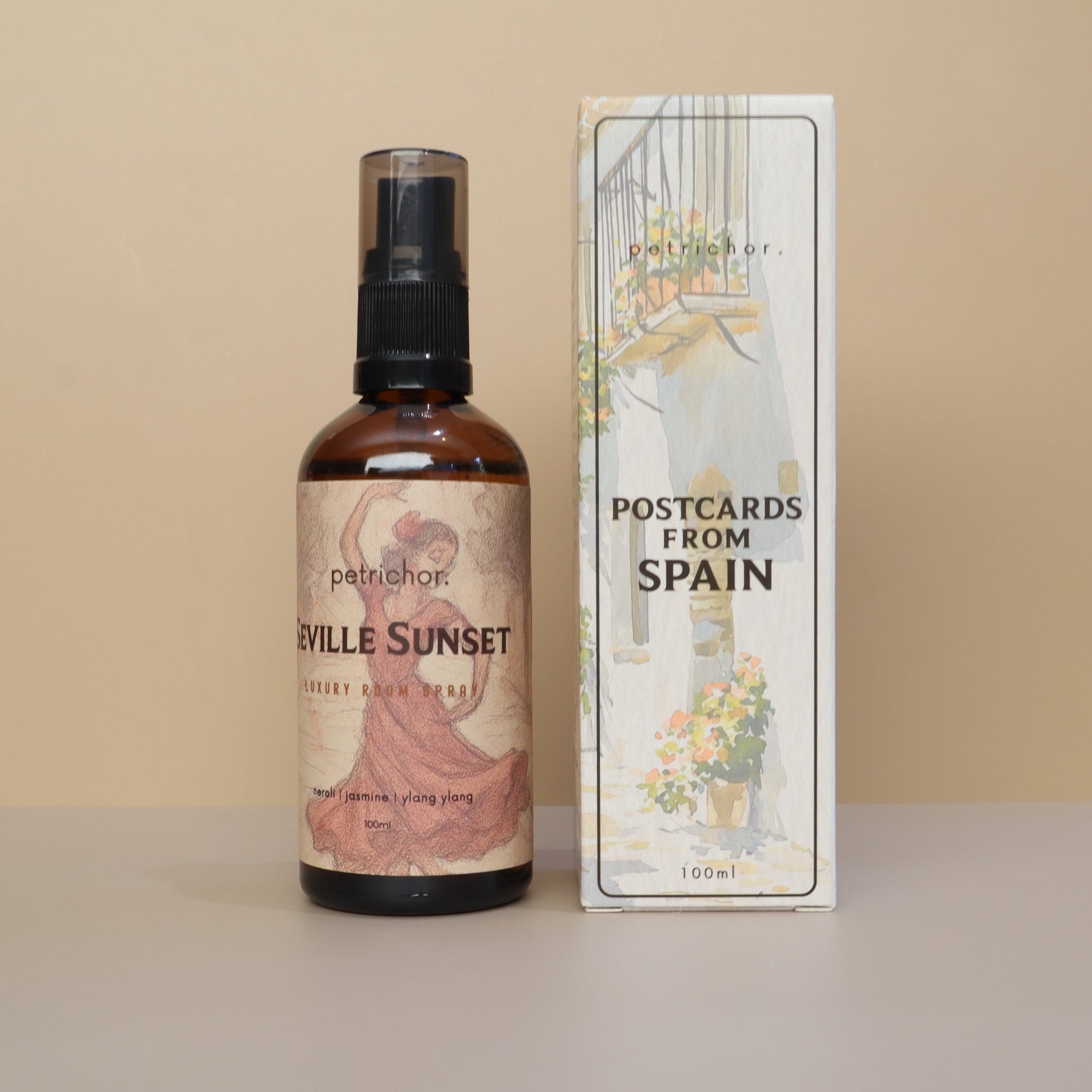 Bottle of 'Seville Sunset' with a box labeled 'Postcards from Spain' on a beige background