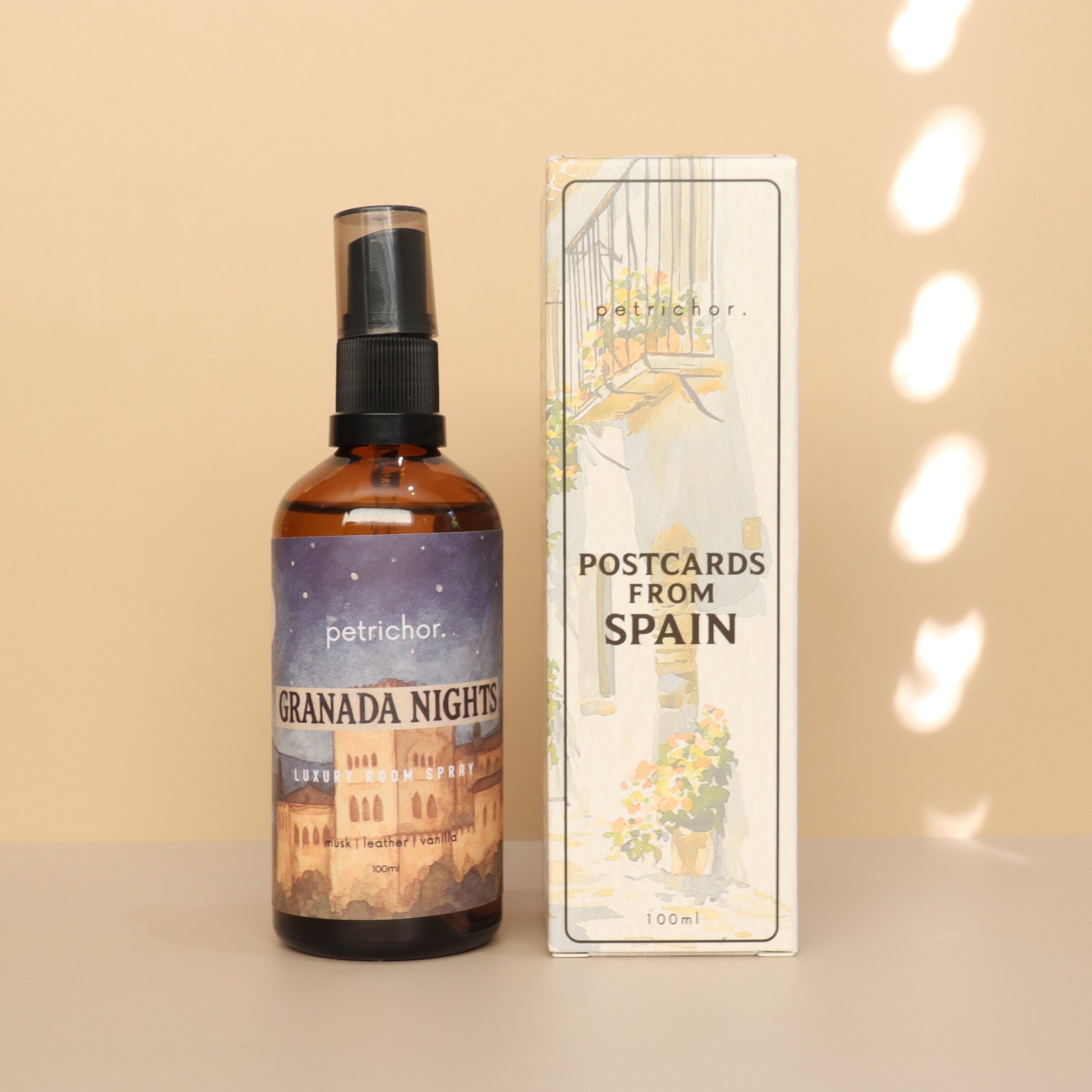 Bottle of 'Granada Nights' with packaging labeled 'Postcards from Spain' on a beige background.