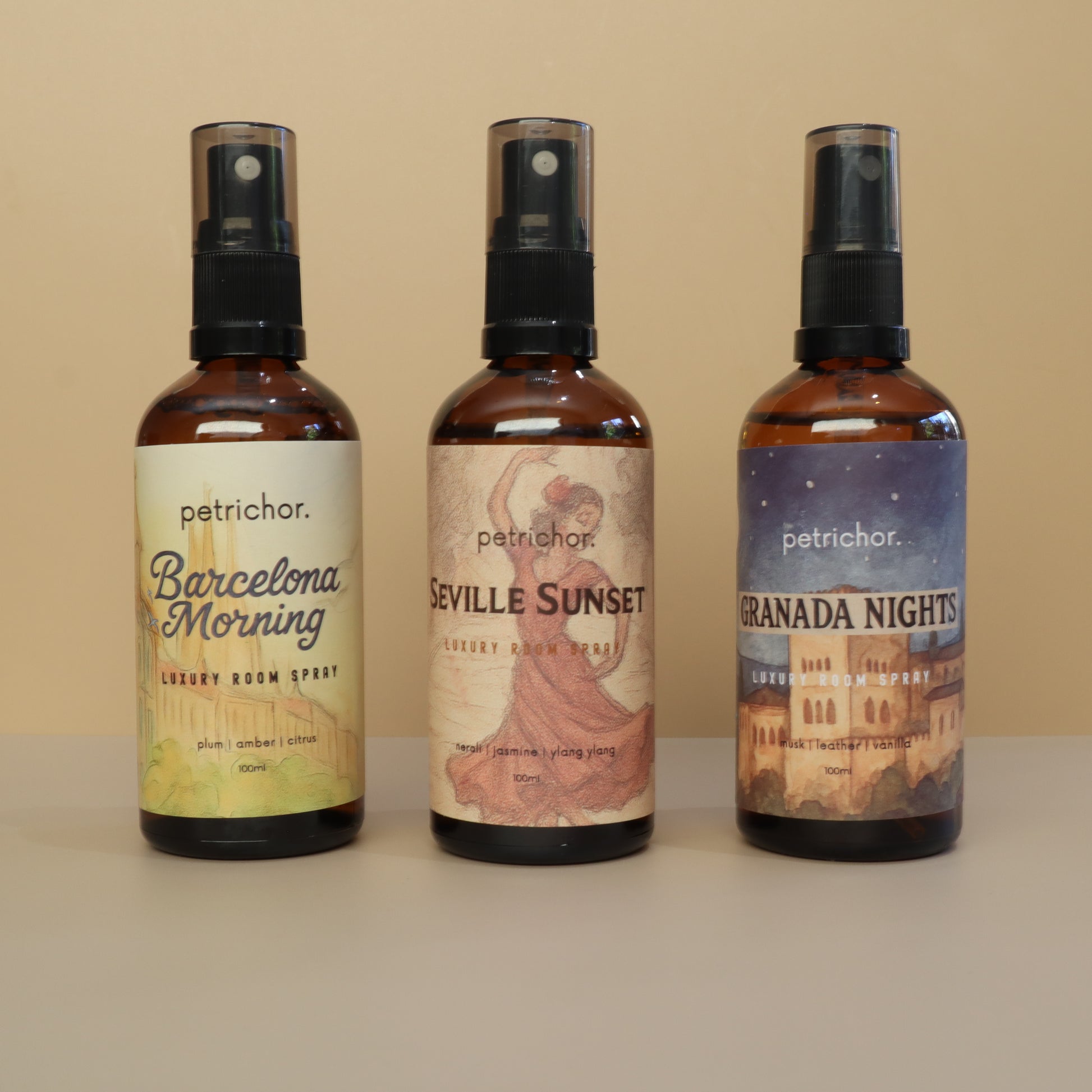 Three bottles of petrichor room sprays with different labels on a beige background