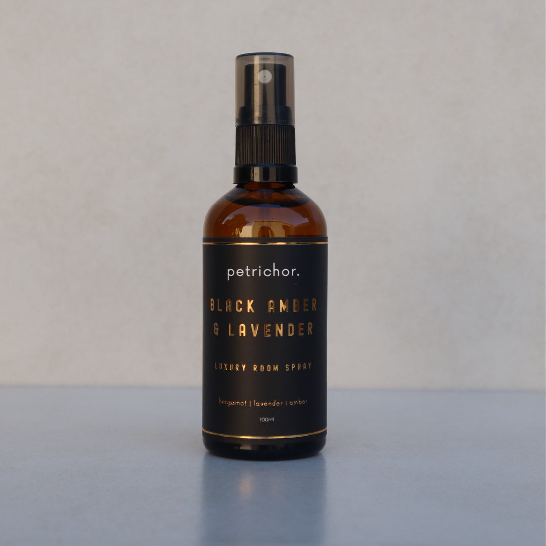 Bottle of petrichor Black Amber & Lavender on a light gray background