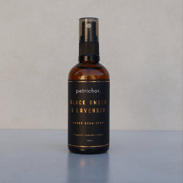 Bottle of petrichor Black Amber & Lavender on a light gray background