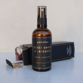 Petrichor Black Amber & Lavender room spray bottle on a light surface with a blurred background