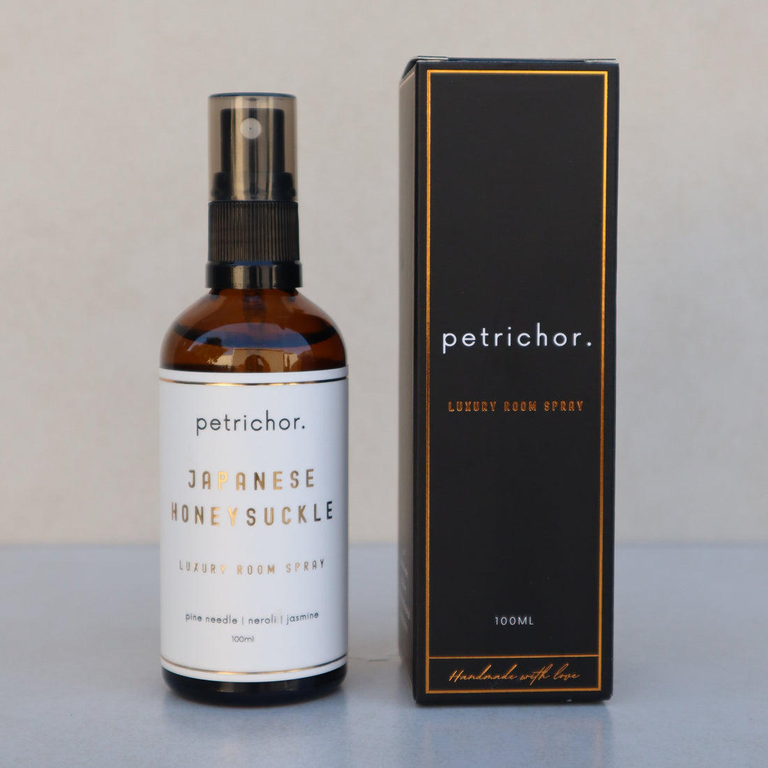 Petrichor Japanese Honeysuckle room spray bottle on a light gray background