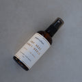 Bottle of petrichor Japanese Honey Luckle spray on a gray background
