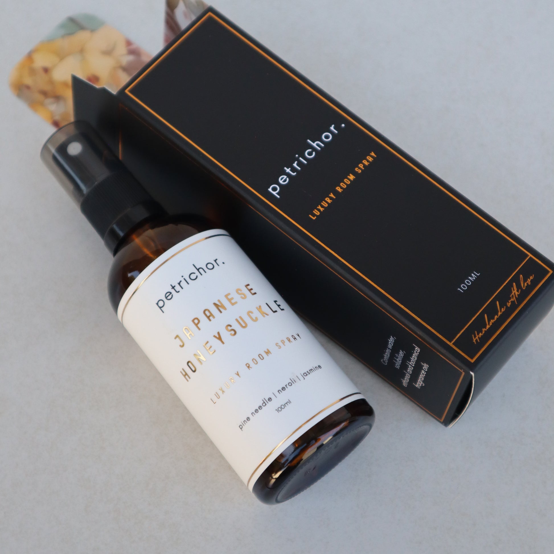 Petrichor Japanese Honeysuetsu room spray with packaging on a light gray background