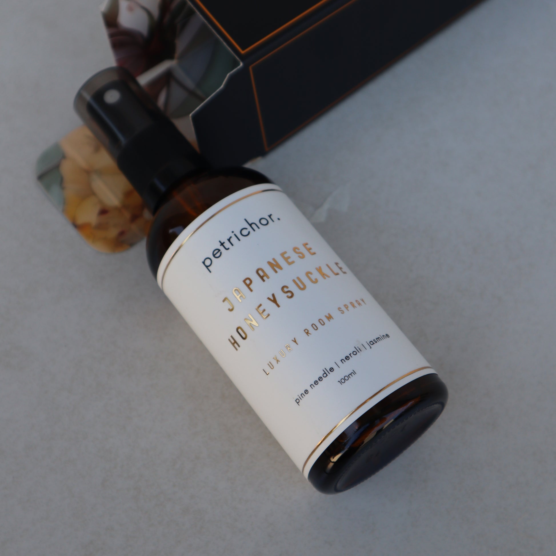 Petrichor Japanese Honeysuckle perfume bottle on a light gray background