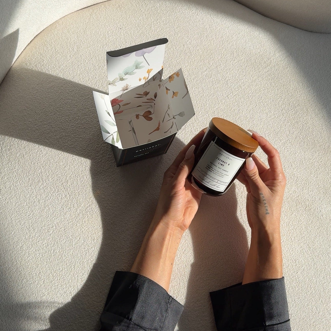 Person holding a jar with a box on a curved surface