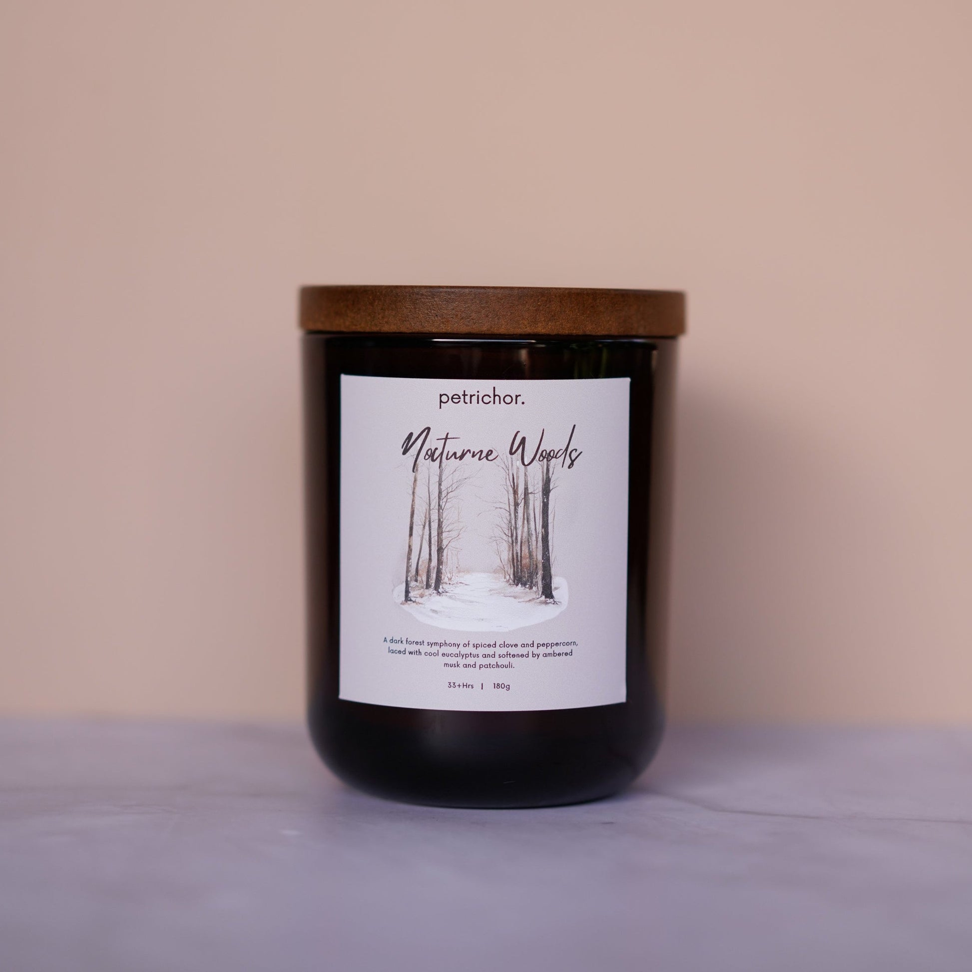 Candle with a label on a beige background